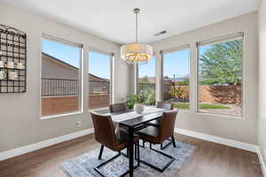 Dining area featuring light wood-style floors and a chandelier