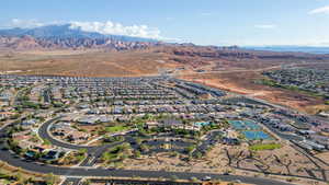 Aerial view of property's location featuring nearby suburban area and mountains