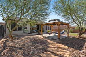 Back of property featuring a patio, a gazebo, stucco siding, and a tile roof