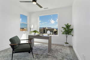 Office featuring light colored carpet and ceiling fan