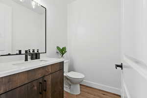 Bathroom featuring vanity and dark wood-type flooring