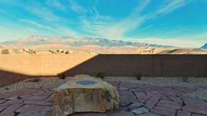 Fenced backyard with a mountain view and a patio