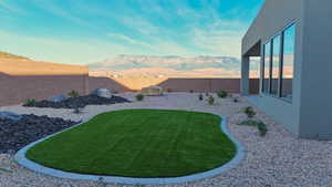 Fenced backyard with a mountain view
