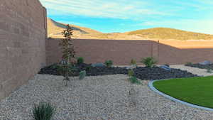 Fenced backyard featuring a mountain view