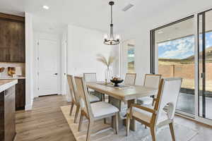 Dining room featuring recessed lighting, light wood-type flooring, and a chandelier