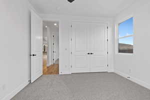 Unfurnished bedroom featuring carpet floors, a closet, recessed lighting, and a ceiling fan