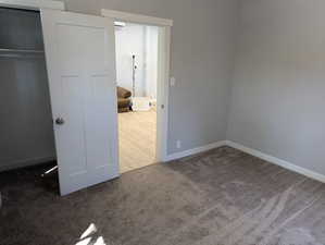 Unfurnished bedroom with carpet and baseboards