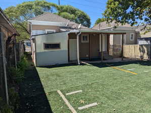 Back of property featuring stucco siding and roof with shingles