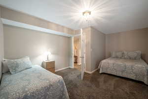 Carpeted bedroom with baseboards