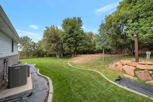 View of grassy yard with a patio