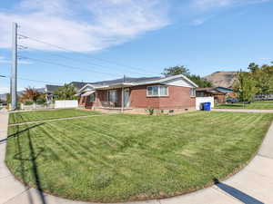 Duplex exterior featuring driveway, brick siding and covered porch