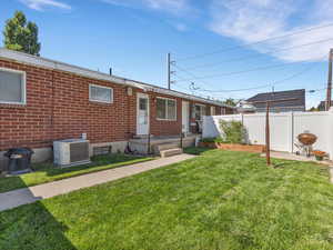 Rear view of house featuring brick siding