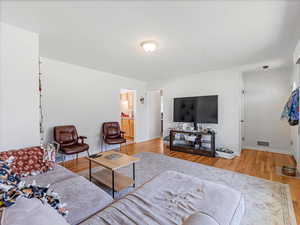Living area with light wood finished floors and baseboards