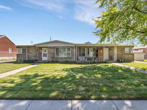 Duplex with brick siding and a front lawn