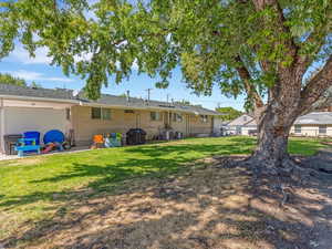 Duplex rear view of property with brick siding and a patio area