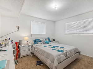 4-plex unit bedroom featuring carpet floors