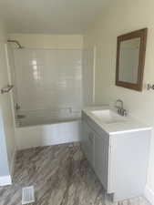 Bathroom with shower / washtub combination and vanity