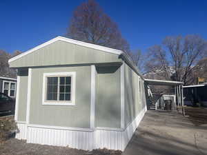 View of side of home featuring an attached carport