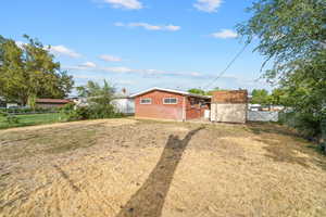 Fenced backyard featuring a storage shed