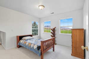 Bedroom 3 with light carpet and multiple windows