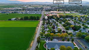 Aerial view of property's location with a mountain backdrop and nearby suburban area