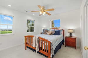 Primary Bedroom featuring light carpet, a ceiling fan, and recessed lighting