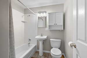 Bathroom featuring shower / tub combo and toilet