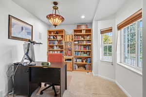 Office area with light carpet and recessed lighting