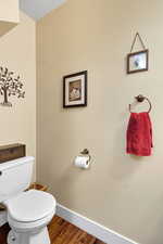 Bathroom with baseboards and dark wood-style floors