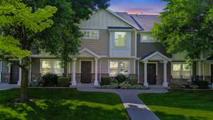 Craftsman inspired home with board and batten siding, a front yard, and stone siding