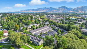 Aerial view of property's location featuring a mountain backdrop and nearby suburban area