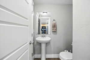 Bathroom featuring toilet and a textured ceiling