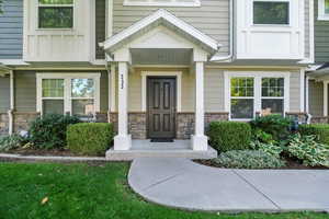 Property entrance featuring stone siding
