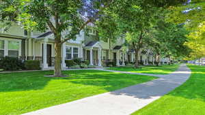 View of front of property with a front yard and stone siding