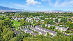 Aerial view of property's location with mountains, nearby suburban area, and a golf club