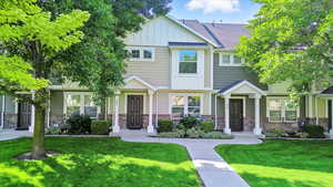 Craftsman inspired home with board and batten siding, a front yard, stone siding, and a shingled roof