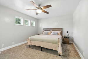 Bedroom featuring light carpet and ceiling fan