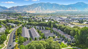 Aerial view of property's location featuring mountains and nearby suburban area