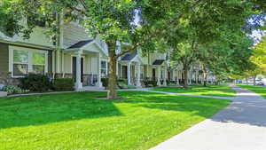 View of front of property with stone siding and a front yard