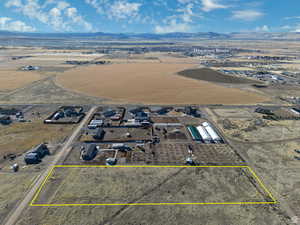 Overview of rural landscape with a mountainous background and property parcel outlined