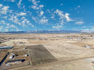 Aerial view of sparsely populated area with a desert landscape and a mountainous background