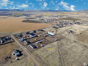 Aerial view of property's location with a mountain backdrop and rural landscape