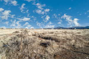 View of mountain backdrop with rural landscape