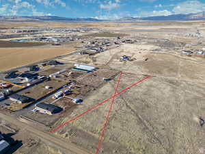 Overview of rural landscape with a mountain backdrop and property parcel outlined