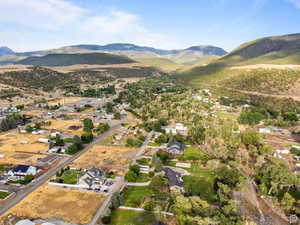 Aerial view of property's location featuring nearby suburban area and a mountain backdrop