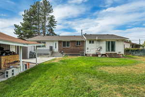 Rear view of property with a patio, entry steps, and brick siding
