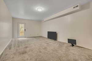 Spare room with carpet and baseboards