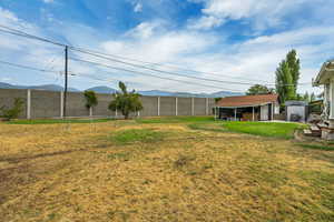 View of yard with a mountain view and an outdoor structure