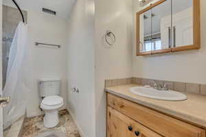 Bathroom featuring vanity and a shower with shower curtain