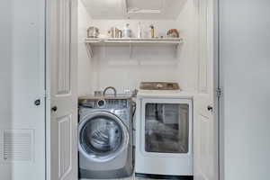 Laundry area featuring separate washer and dryer